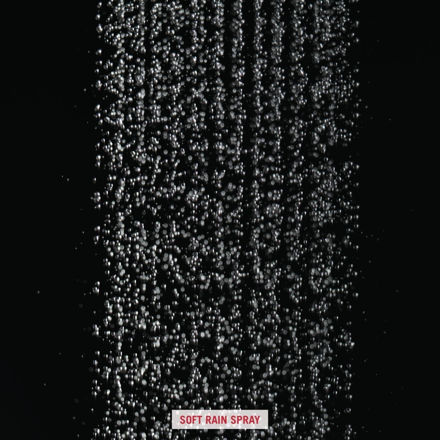 Stainless steel raincan shower head dispensing water in soft rain spray pattern against dark background.