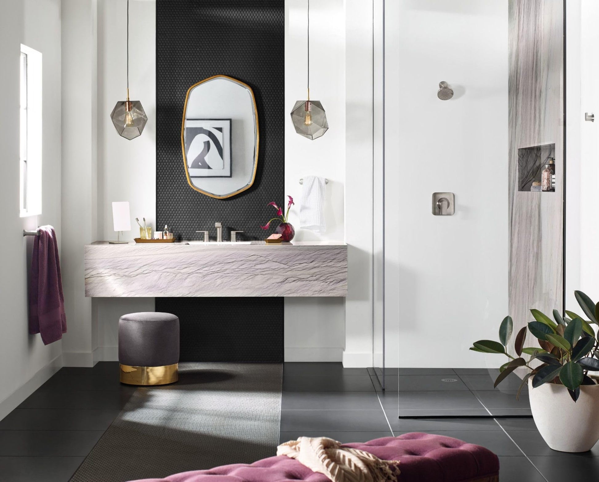 Brushed nickel hand towel bar mounted on white bathroom wall near vanity sink.