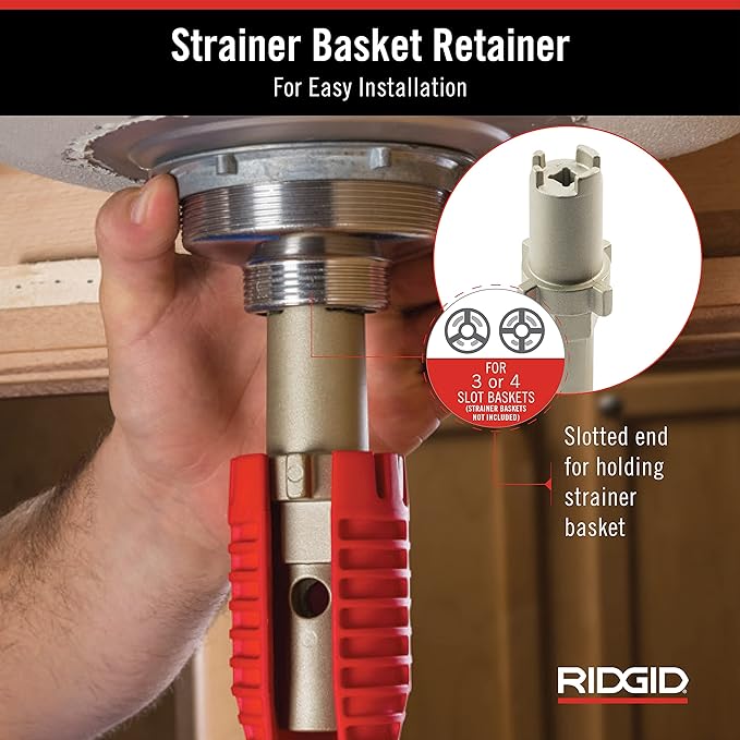 Hand holding metal tool with red grip and slotted end for faucet strainer basket installation and removal.