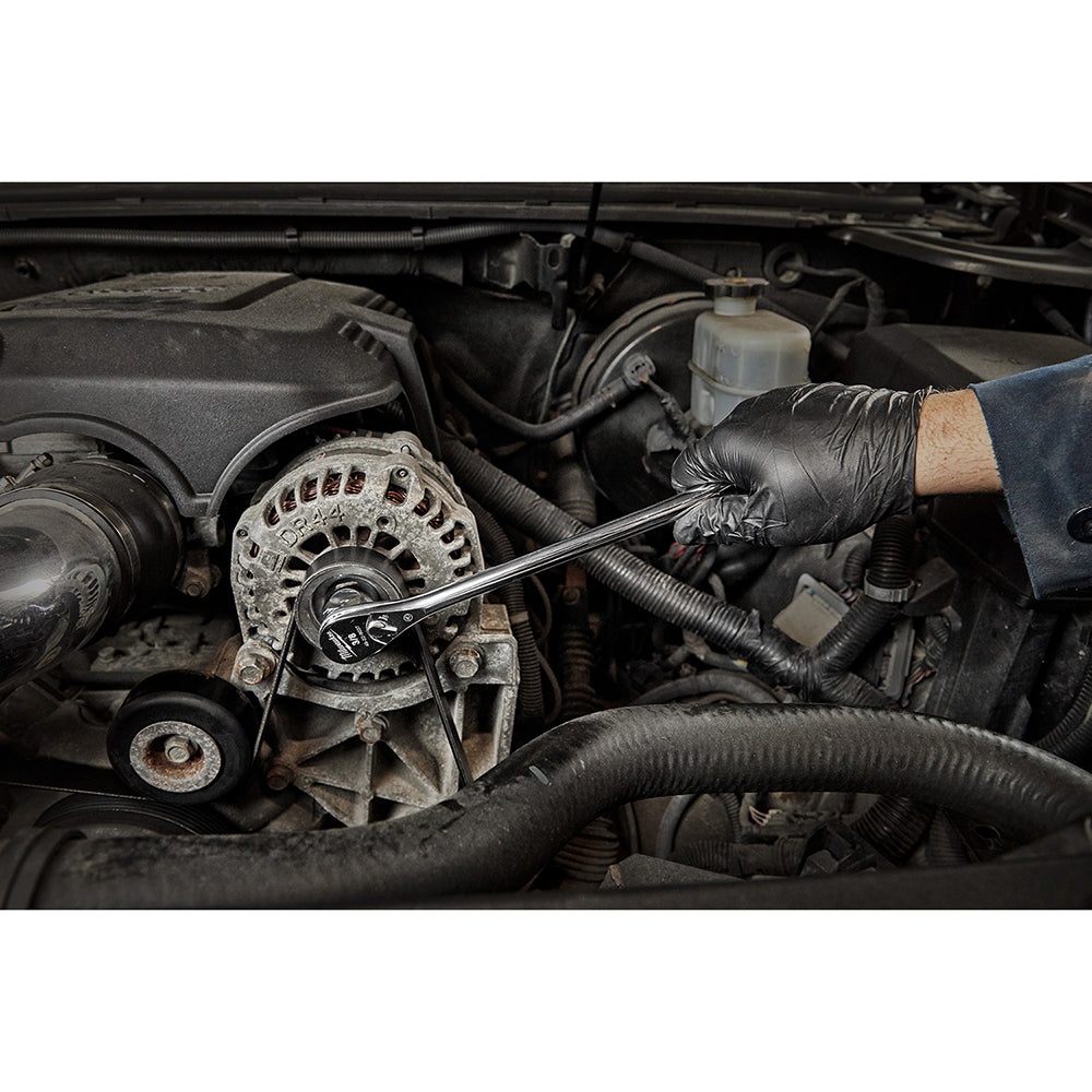 Chrome ratchet being used on engine alternator pulley in automotive setting.