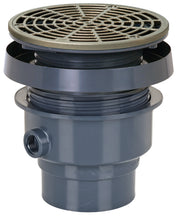 Nickel bronze round drain grate with radial pattern mounted on gray PVC hub assembly with inlet connection.