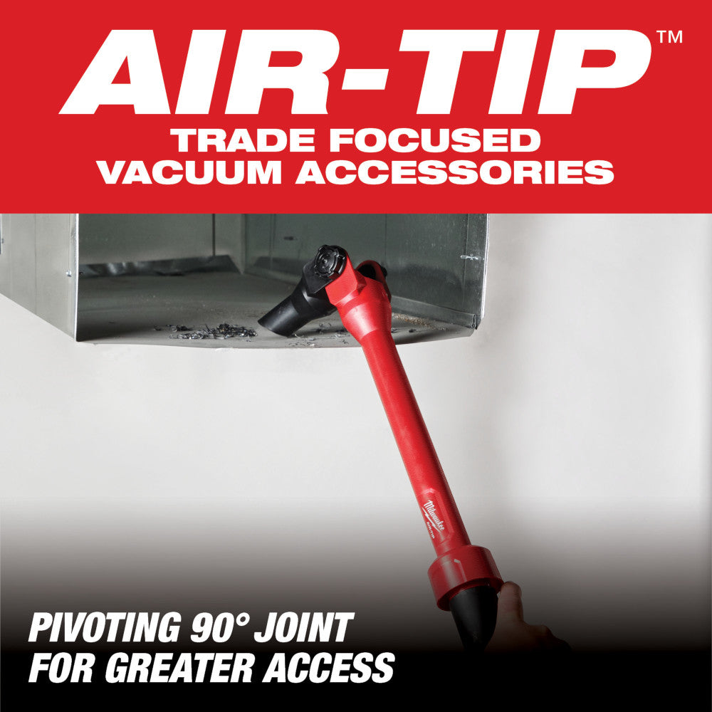 Red and black pivoting extension wand with 90-degree joint connector, demonstrated reaching under equipment.