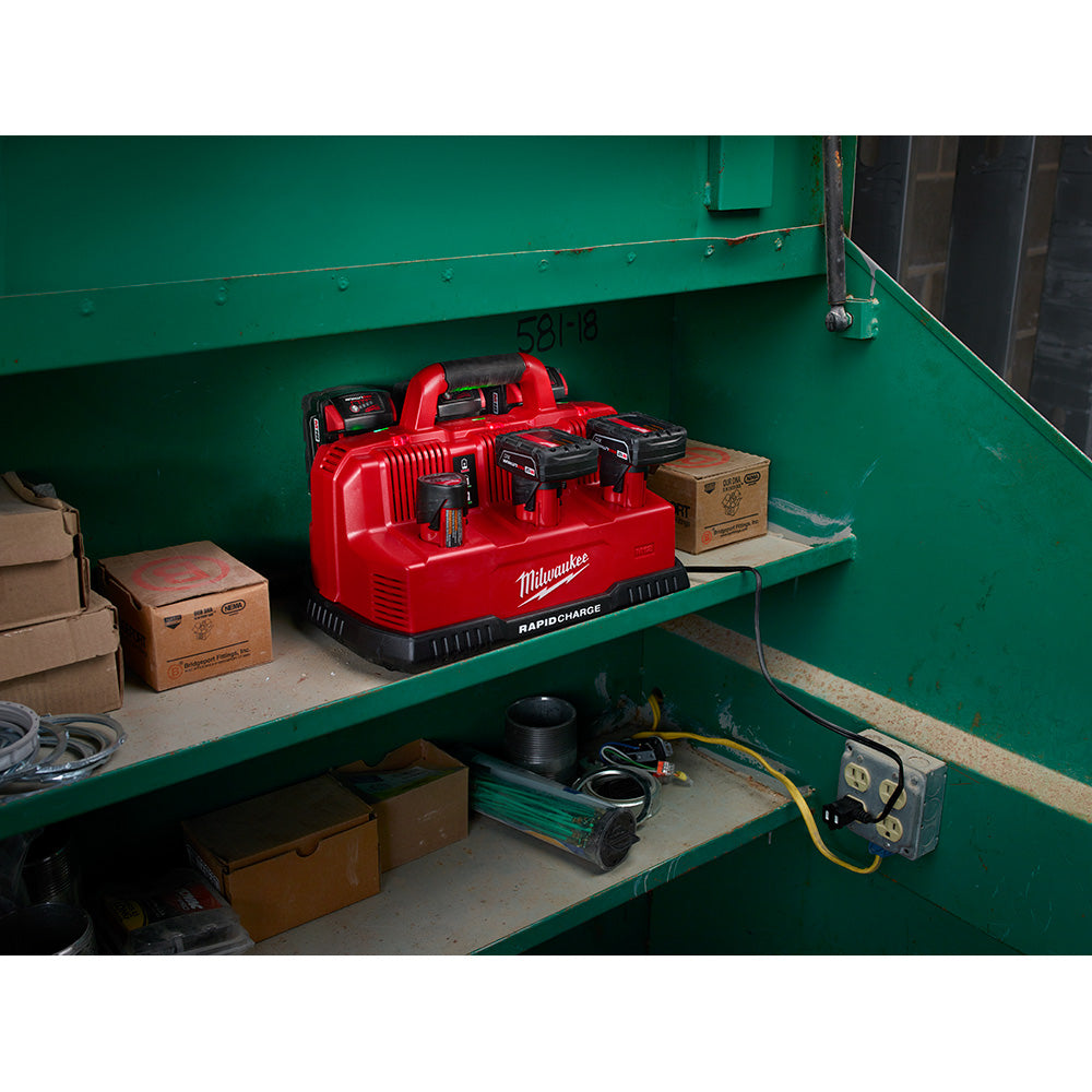 Red Milwaukee rapid charge station with multiple battery charging ports mounted on green metal shelving.