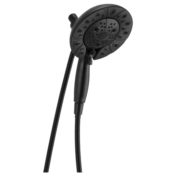 Black round shower head with multiple spray holes connected to a black handheld unit by a coiled hose.