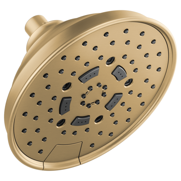 Round brushed gold shower head with multiple spray holes and dark gray adjustable nozzle sections mounted on wall bracket.