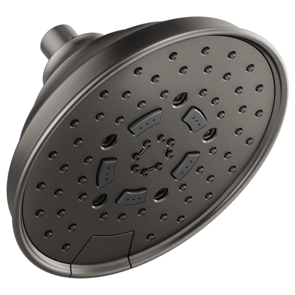 Round brushed nickel shower head with multiple spray holes and adjustable jet nozzles mounted on wall bracket.