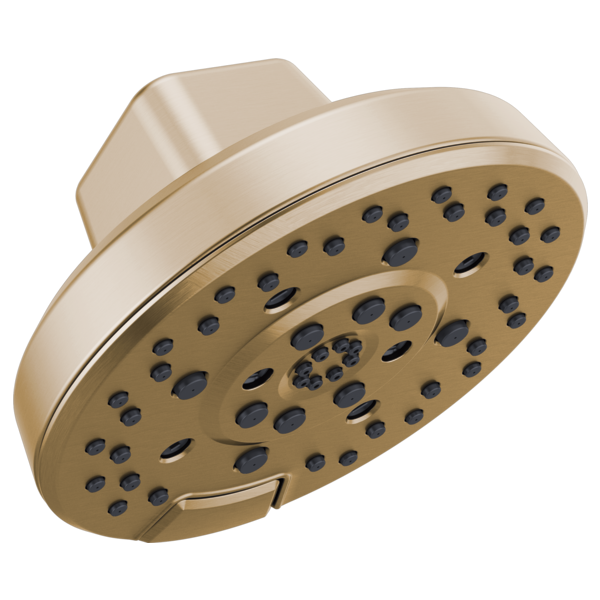Round champagne bronze shower head with multiple spray holes and curved arm mount.