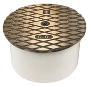 Nickel bronze PVC cleanout fitting with textured cover marked "C.O." and white cylindrical body.