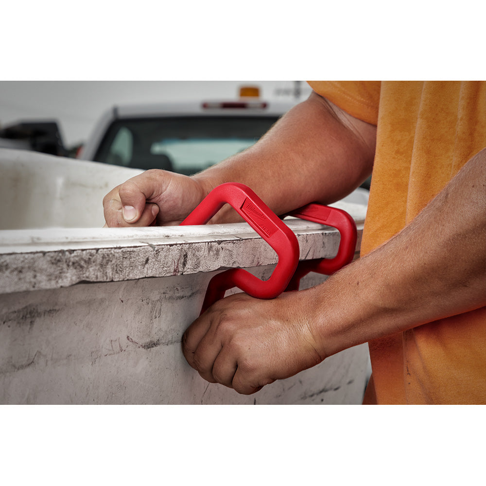 Red plastic bucket hook clipped onto rim of white bucket, held by person's hands.
