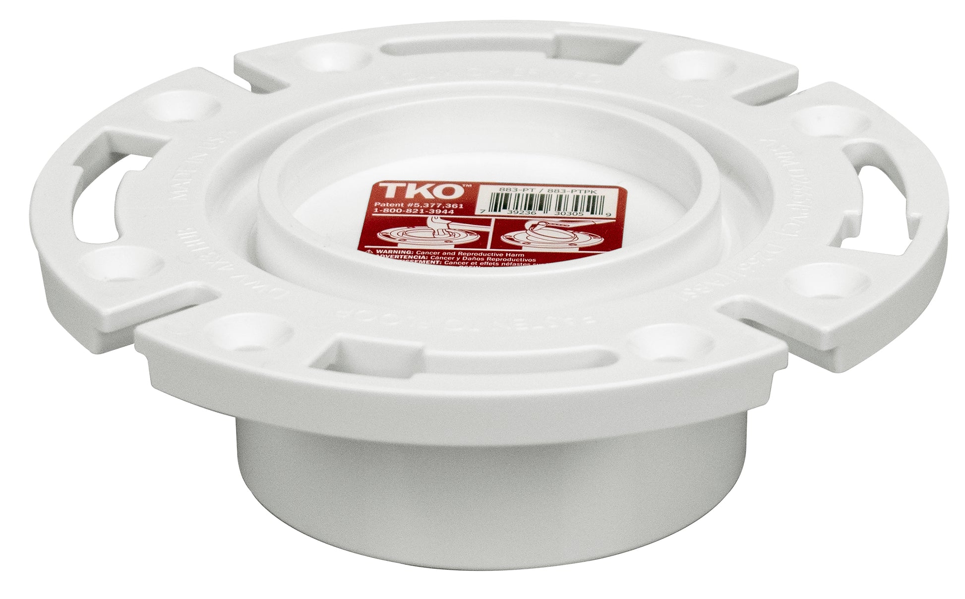 White PVC closet flange with four handles and knockout opening, red label visible on top surface.