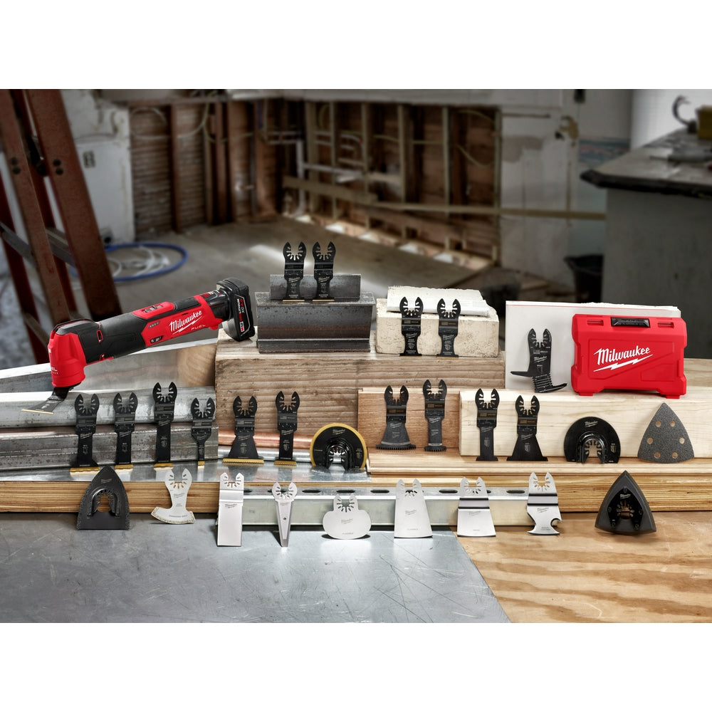 Red Milwaukee oscillating multi-tool with black OPEN-LOK blade attachments displayed in organized wooden and plastic storage 