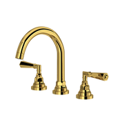 Unlacquered brass three-piece lavatory faucet with curved C-spout and lever handles.