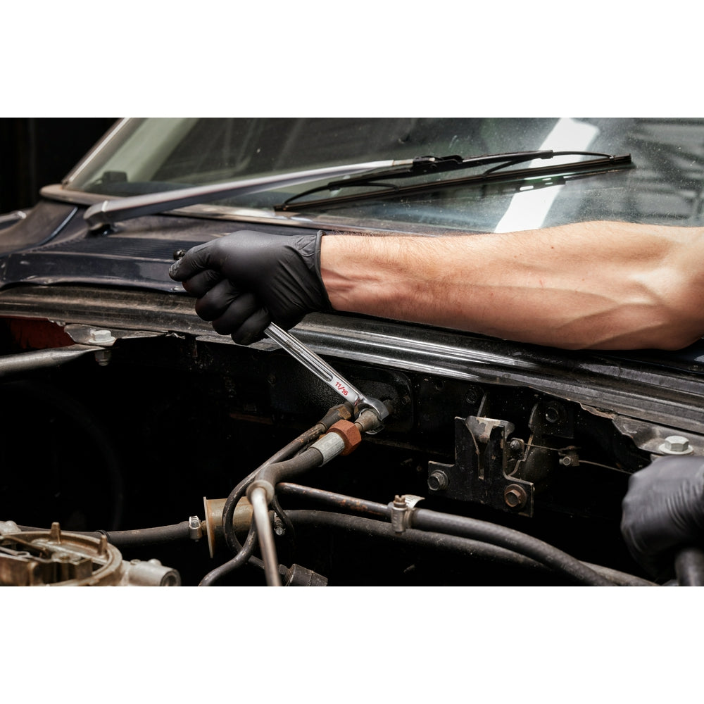 Double end flare nut wrench with metal construction being used on automotive brake line fitting.