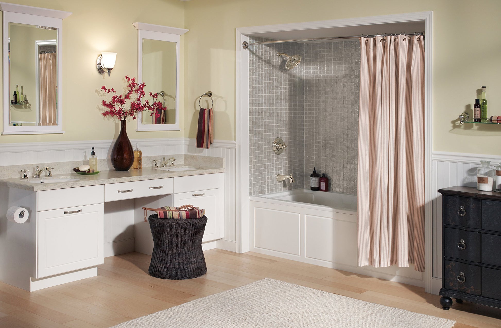 Polished nickel bathroom faucet with metal cross handles mounted on white vanity countertop in bathroom setting.