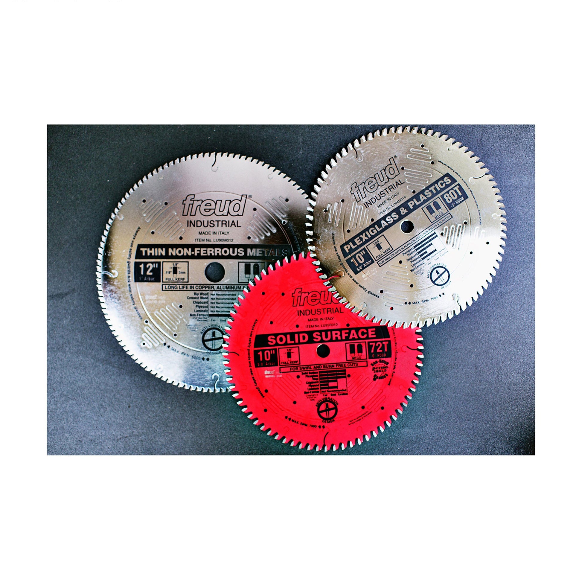 Three circular saw blades with teeth around edges: two silver blades labeled for thin non-ferrous metals and laminate/melamin