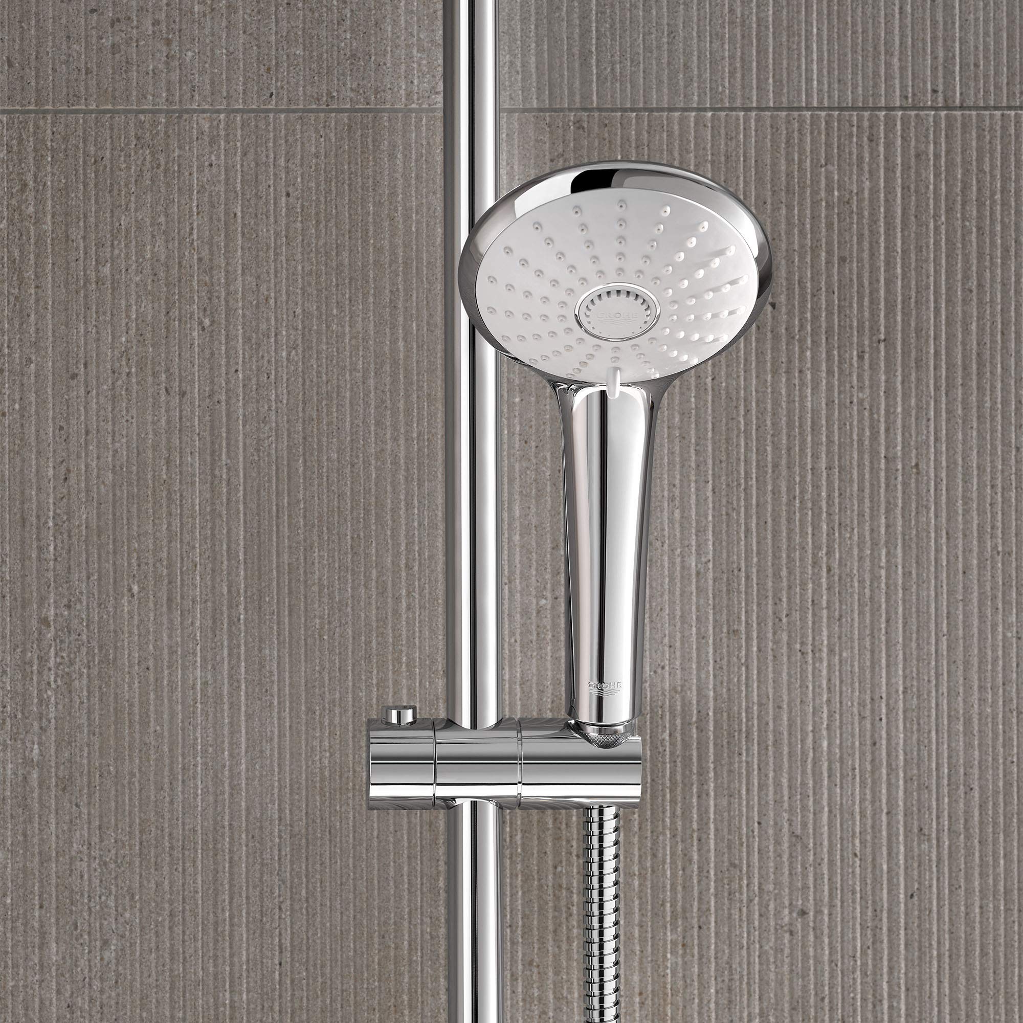 Chrome thermostatic shower system with round rainfall showerhead and vertical rail mount on tiled wall.