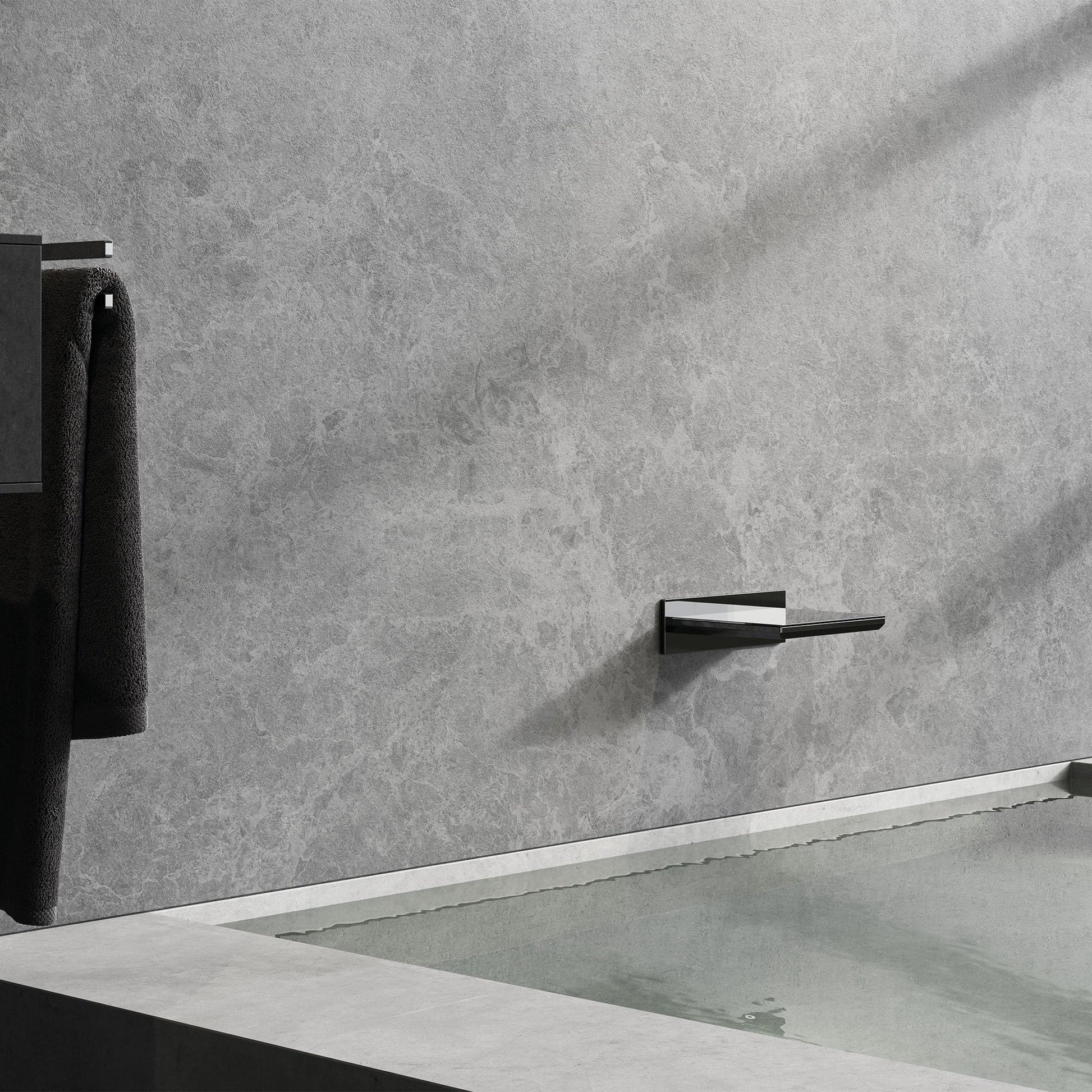 Chrome waterfall tub spout with angular design mounted on gray tile wall above bathtub.