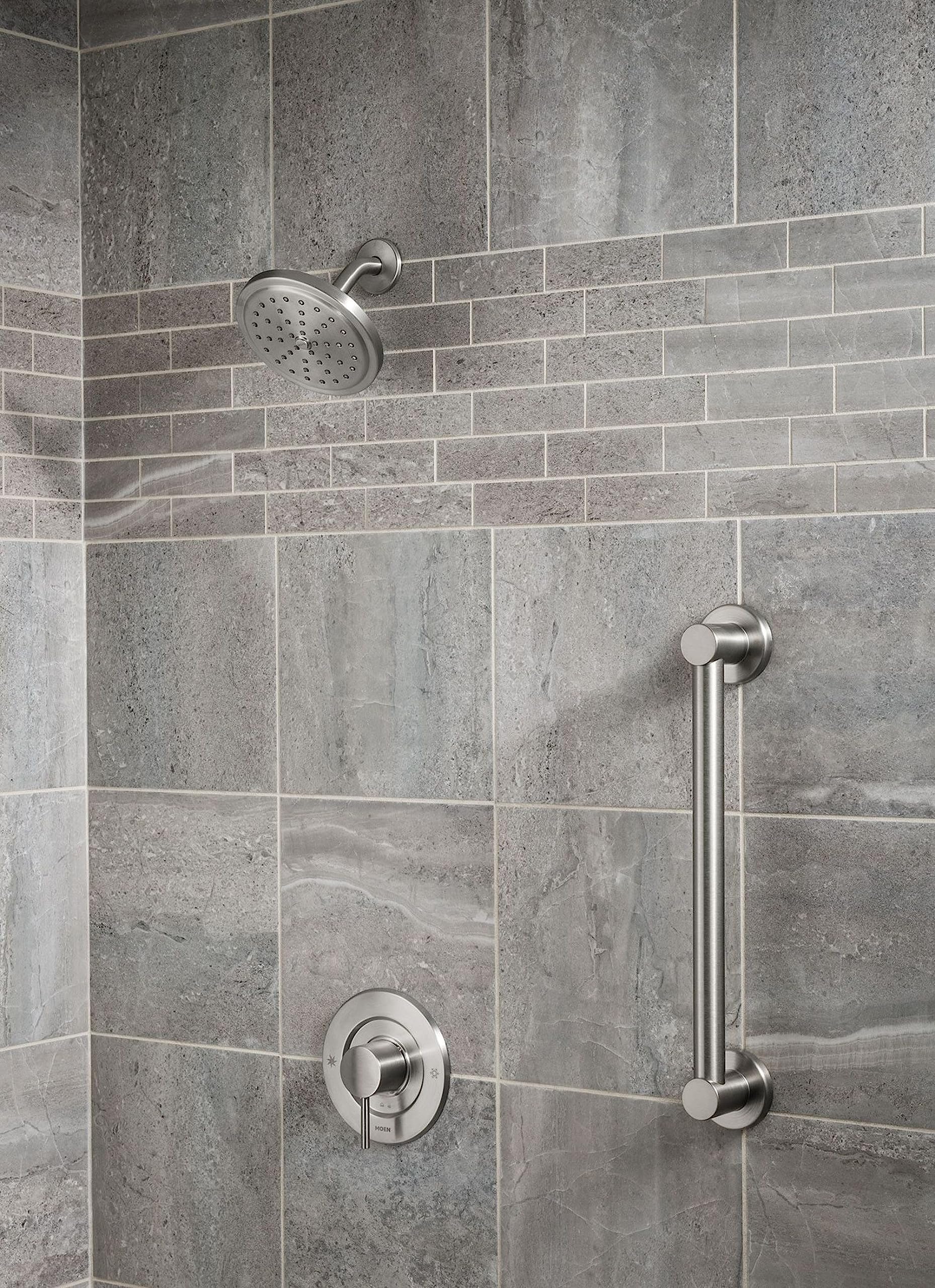 Brushed nickel 42-inch stainless steel grab bar mounted vertically on tiled shower wall beside showerhead and valve controls.