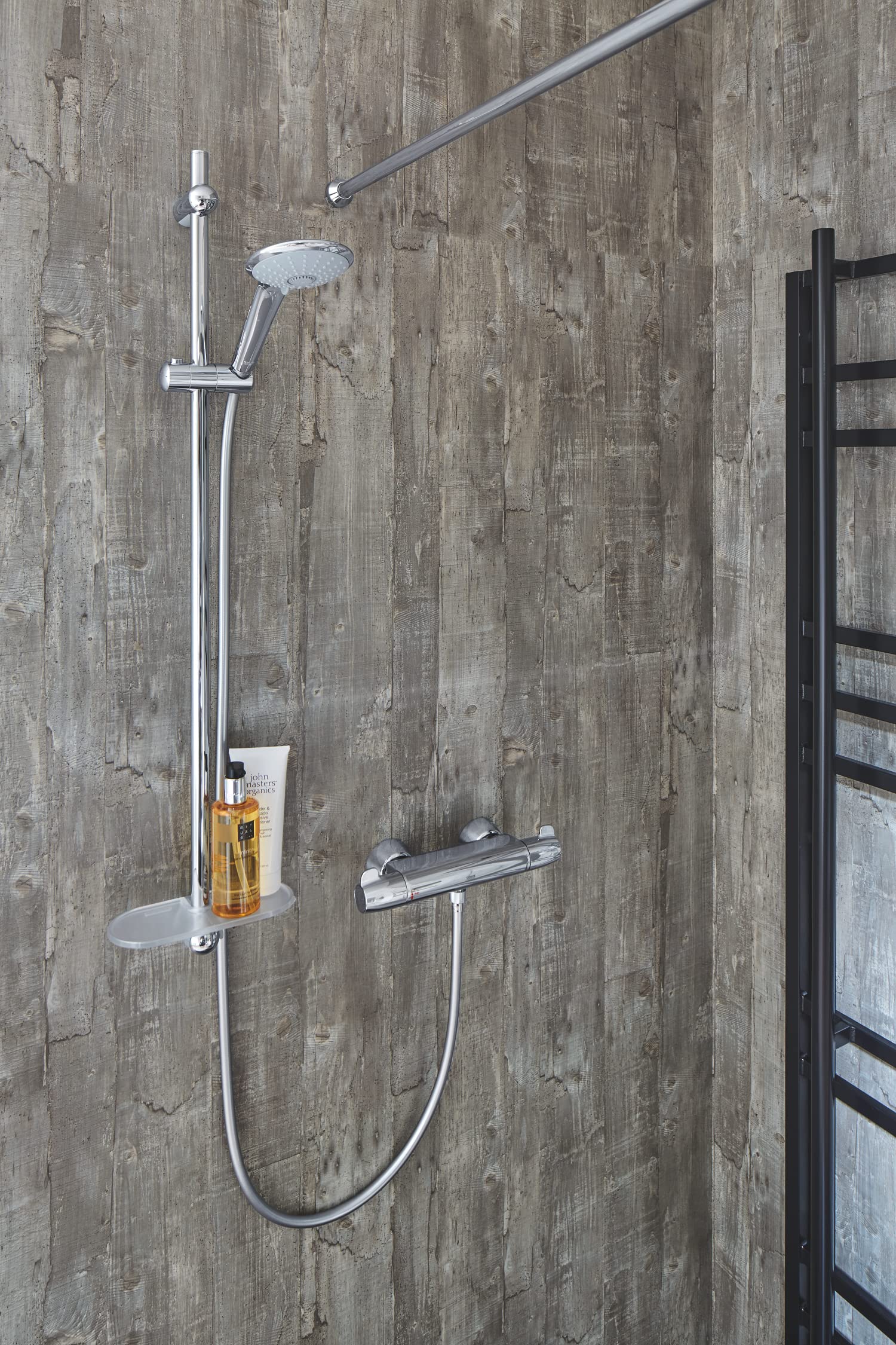 Chrome hand shower with three spray settings mounted on vertical rail with integrated shelf and thermostatic valve.