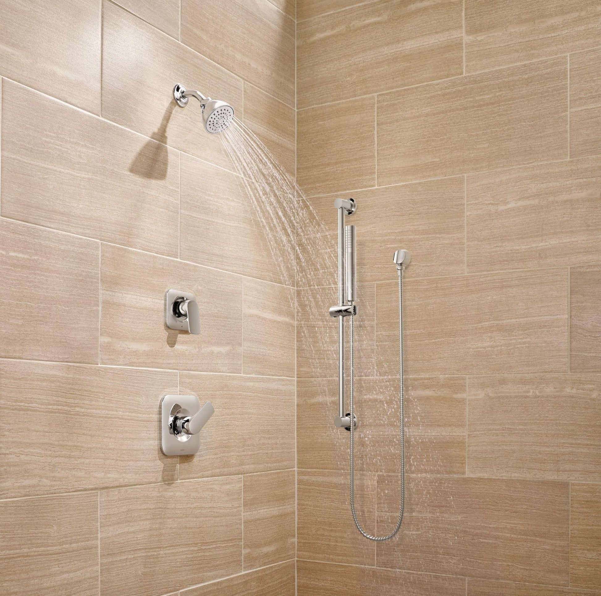 Chrome handheld shower system with slide bar, metal hose, and fixed showerhead mounted on tiled bathroom wall.