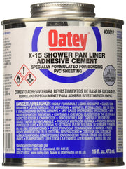 White Oatey X-15 PVC solvent cement adhesive can with metal lid and blue label, 16 fl. oz. size.
