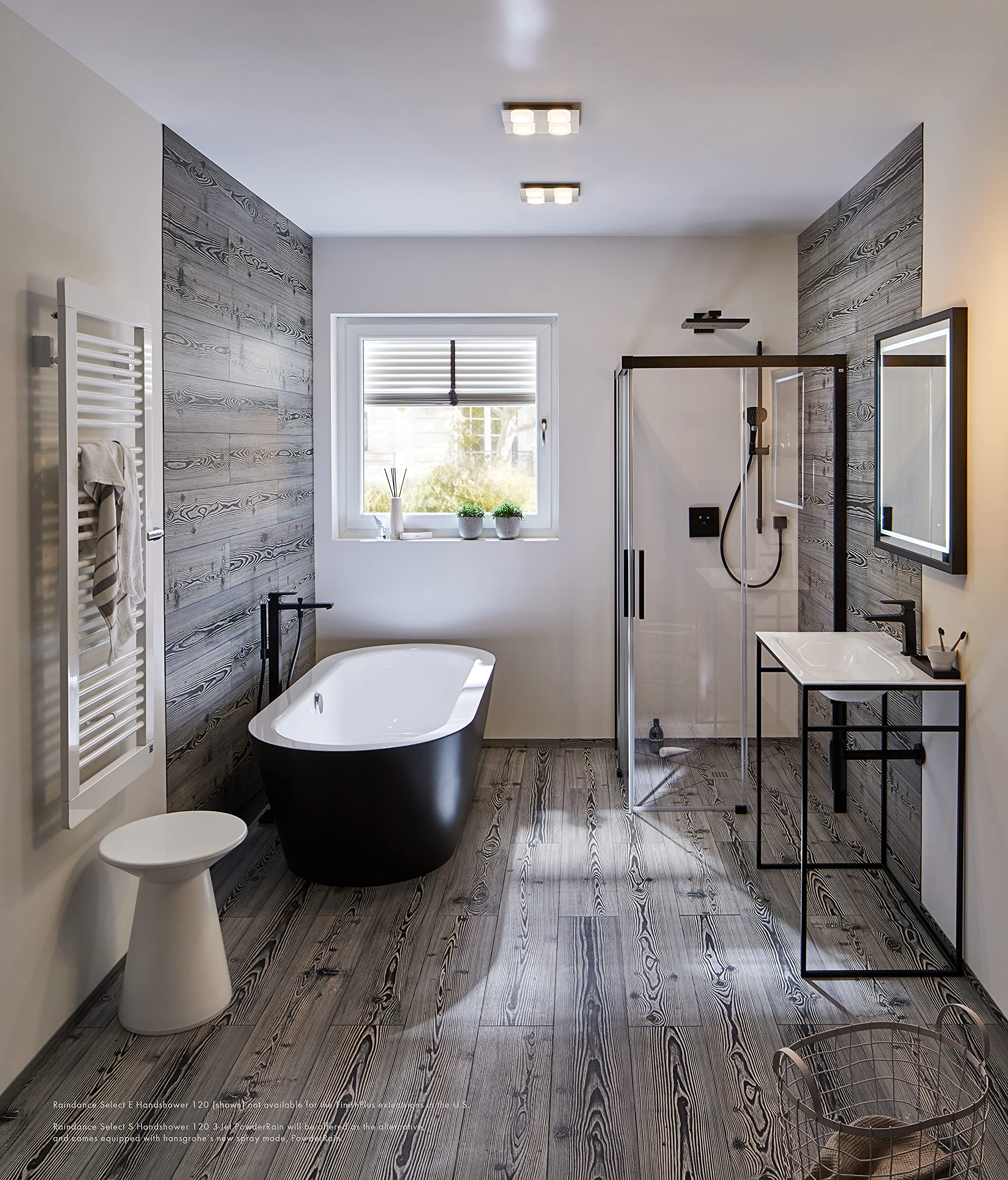 Matte black square thermostatic shower trim with dual function controls mounted on gray wood-textured bathroom wall.