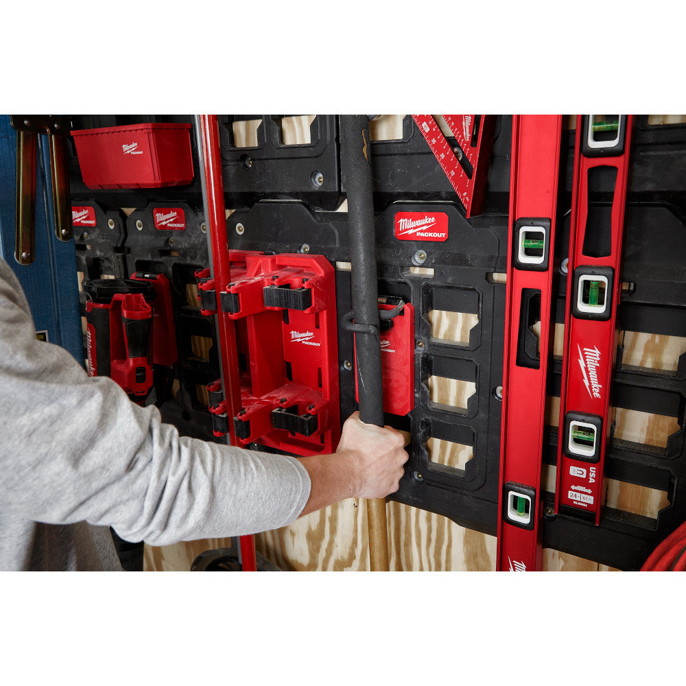 Red plastic S-hook attached to Milwaukee PACKOUT tool storage system on wall.