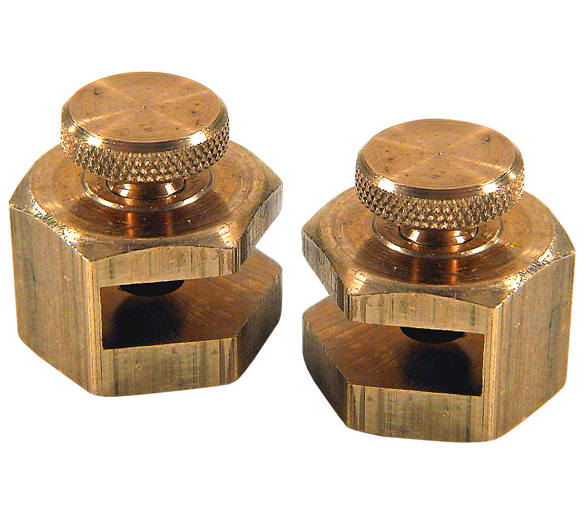 Two brass hexagonal stair gauges with knurled adjustment knobs and open notches for mounting on square surfaces.