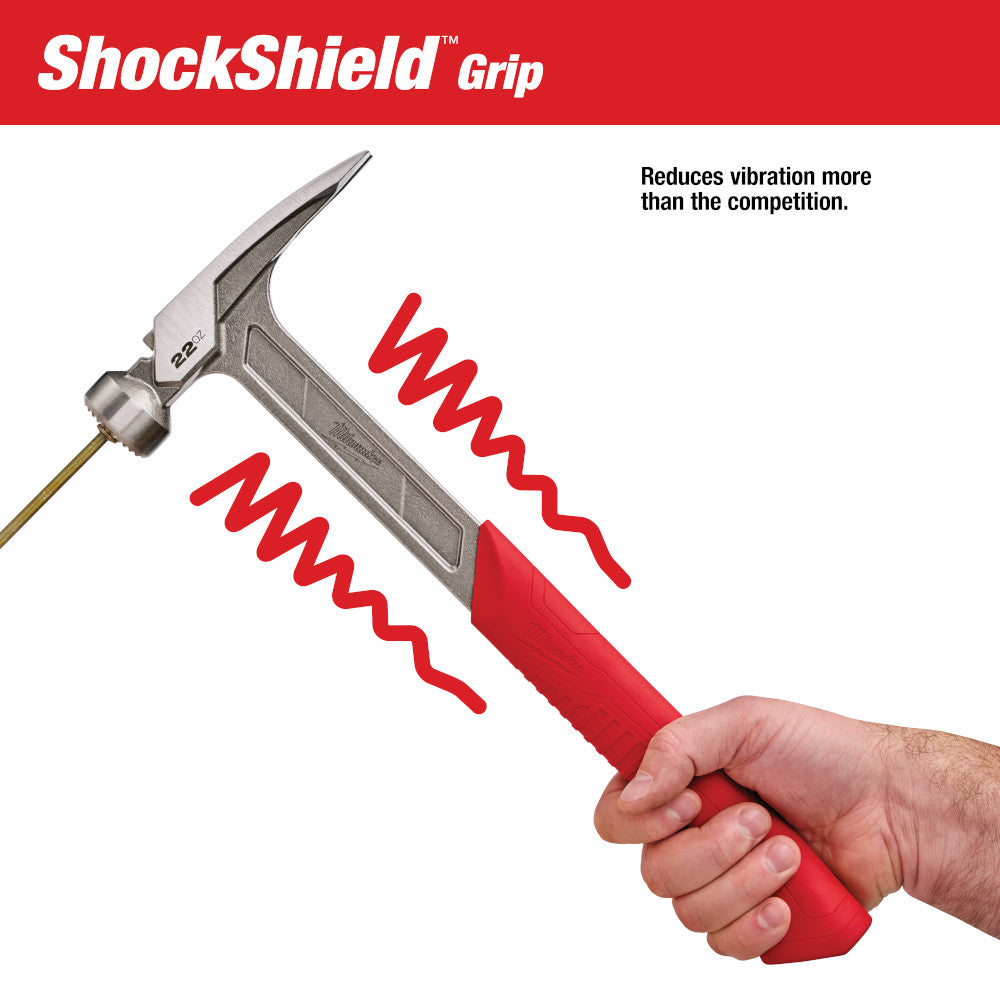 Framing hammer with milled face head, brass shaft, and red ShockShield grip held in hand.