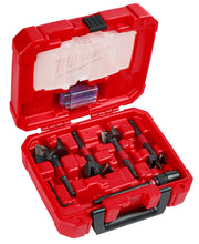 Red Milwaukee case with five black SWITCHBLADE selfeed drill bits of varying sizes arranged in foam compartments.