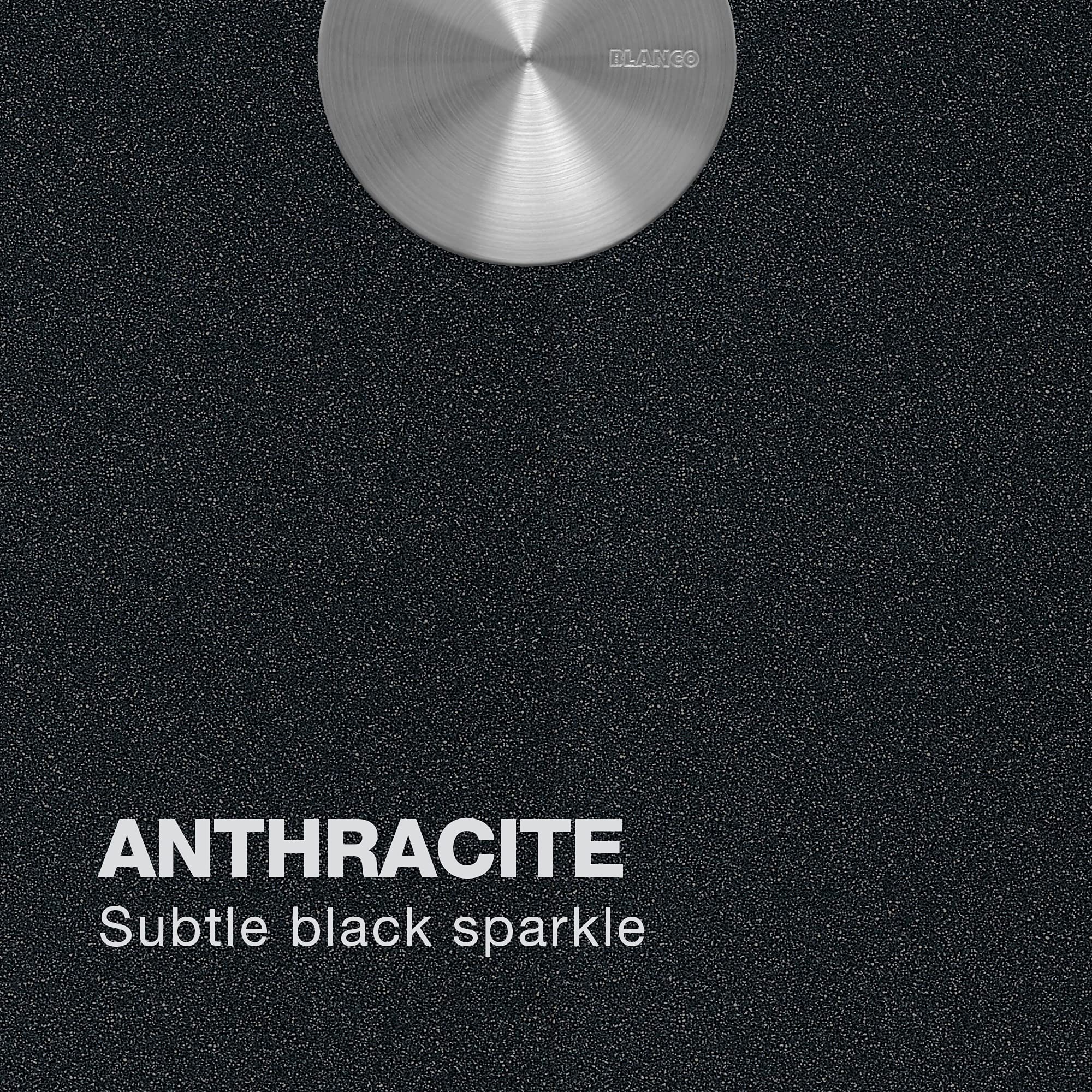 Anthracite composite sink surface with subtle black sparkle finish and stainless steel drain fitting.