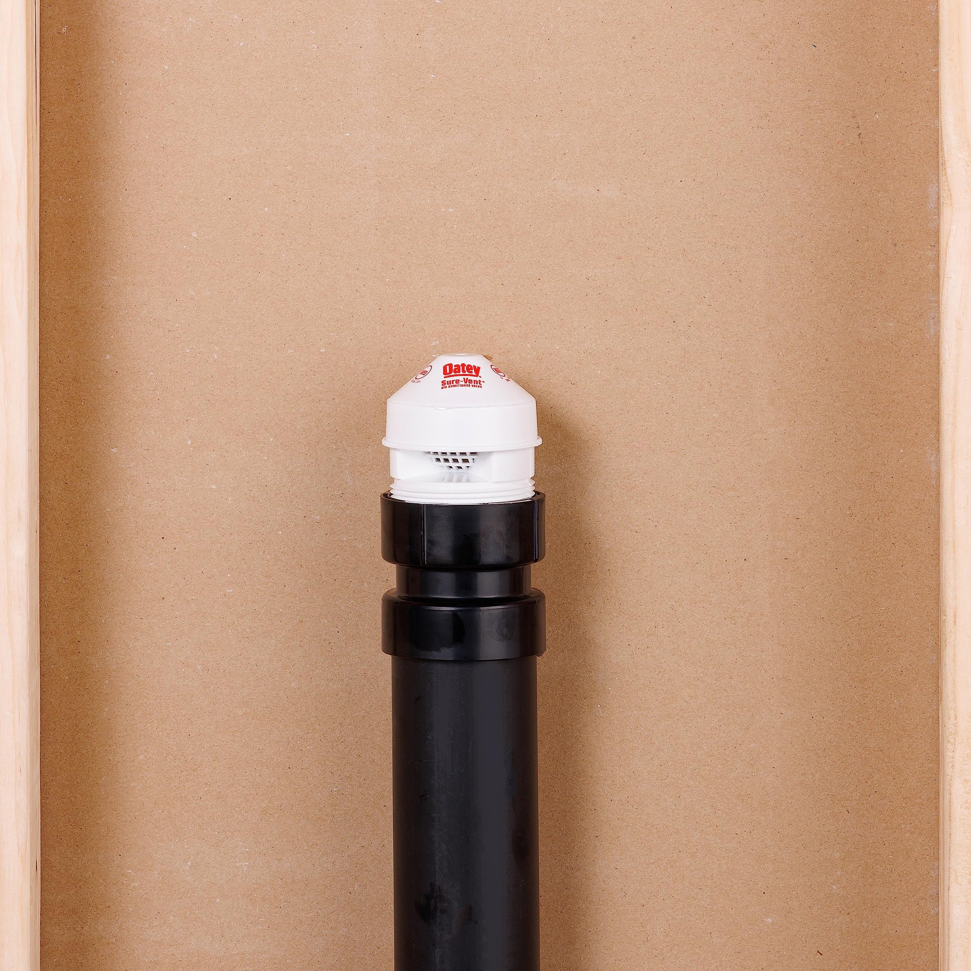 Black ABS pipe with white air admittance valve cap featuring Oatey branding on top.