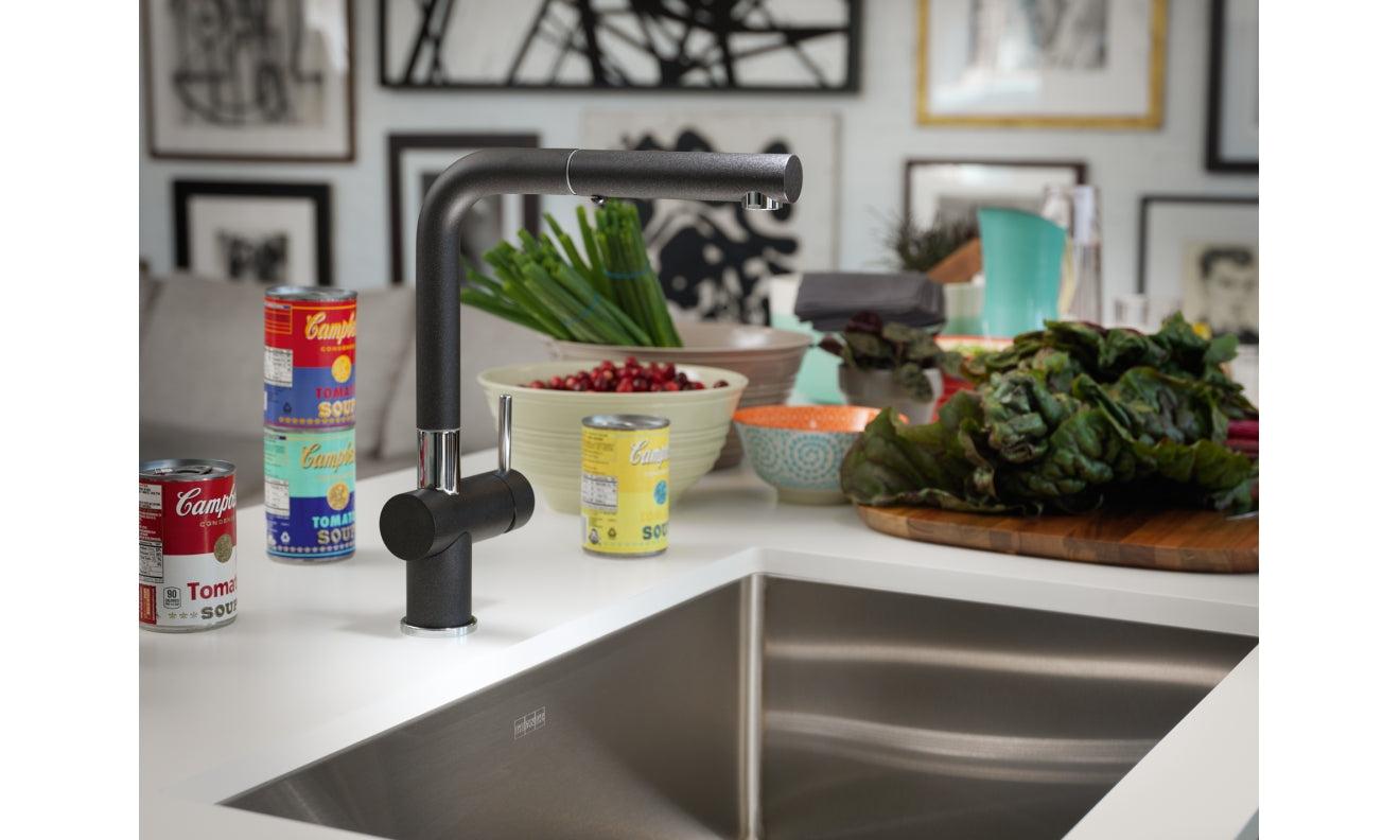 Stainless steel single bowl undermount sink with black pull-down faucet installed in white countertop.