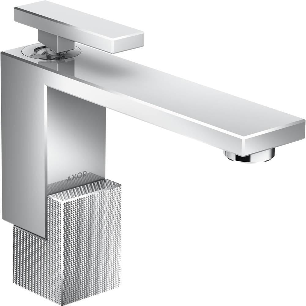 Chrome single-hole bathroom faucet with rectangular spout, textured base, and lever handle mounted on white countertop.