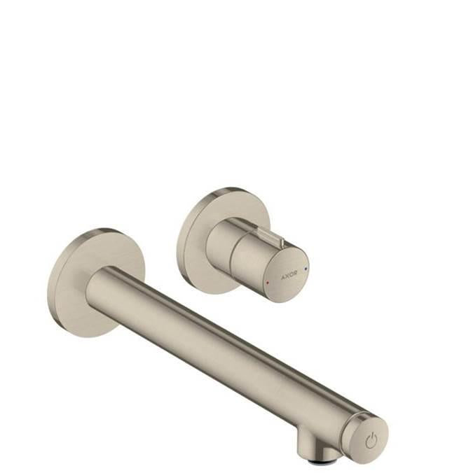 Brushed nickel wall-mounted faucet trim with cylindrical spout and separate control handle mounted on circular escutcheons.
