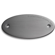Brushed black chrome finish sample chip with two mounting holes and embossed text.