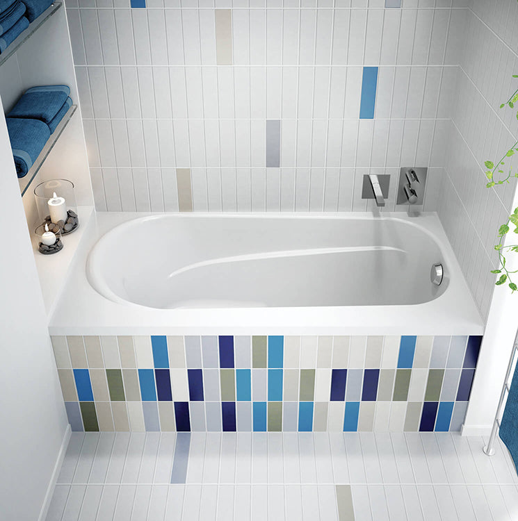 Biscuit-colored rectangular soaking bathtub with raised seat and rounded interior, installed in tiled alcove with chrome fixt