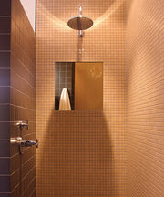 Rectangular fog-free mirror mounted in tiled shower enclosure with overhead rainfall showerhead and wall-mounted fixtures.