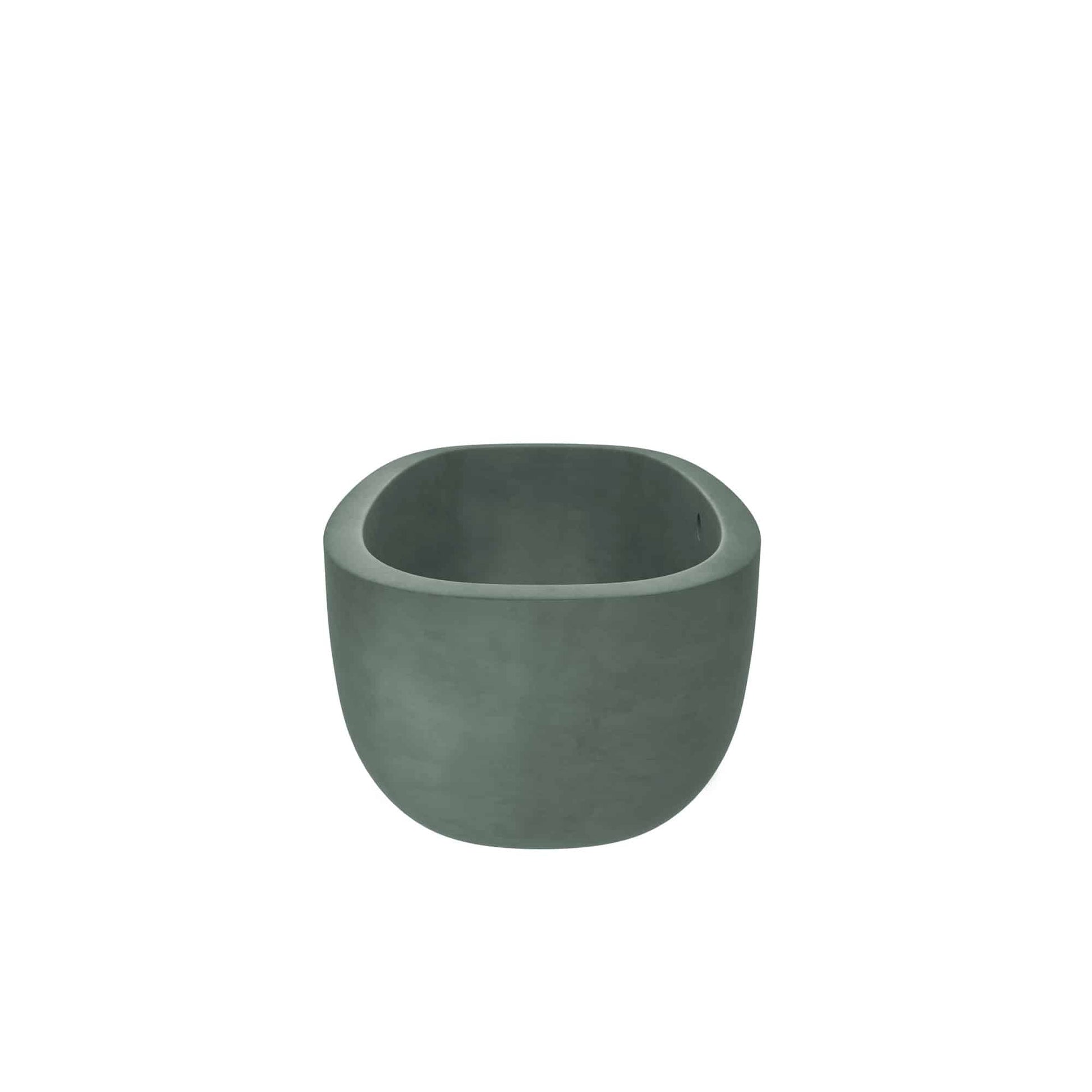 Forest green concrete soaking tub with rounded edges and wide rim, shown from front angle.