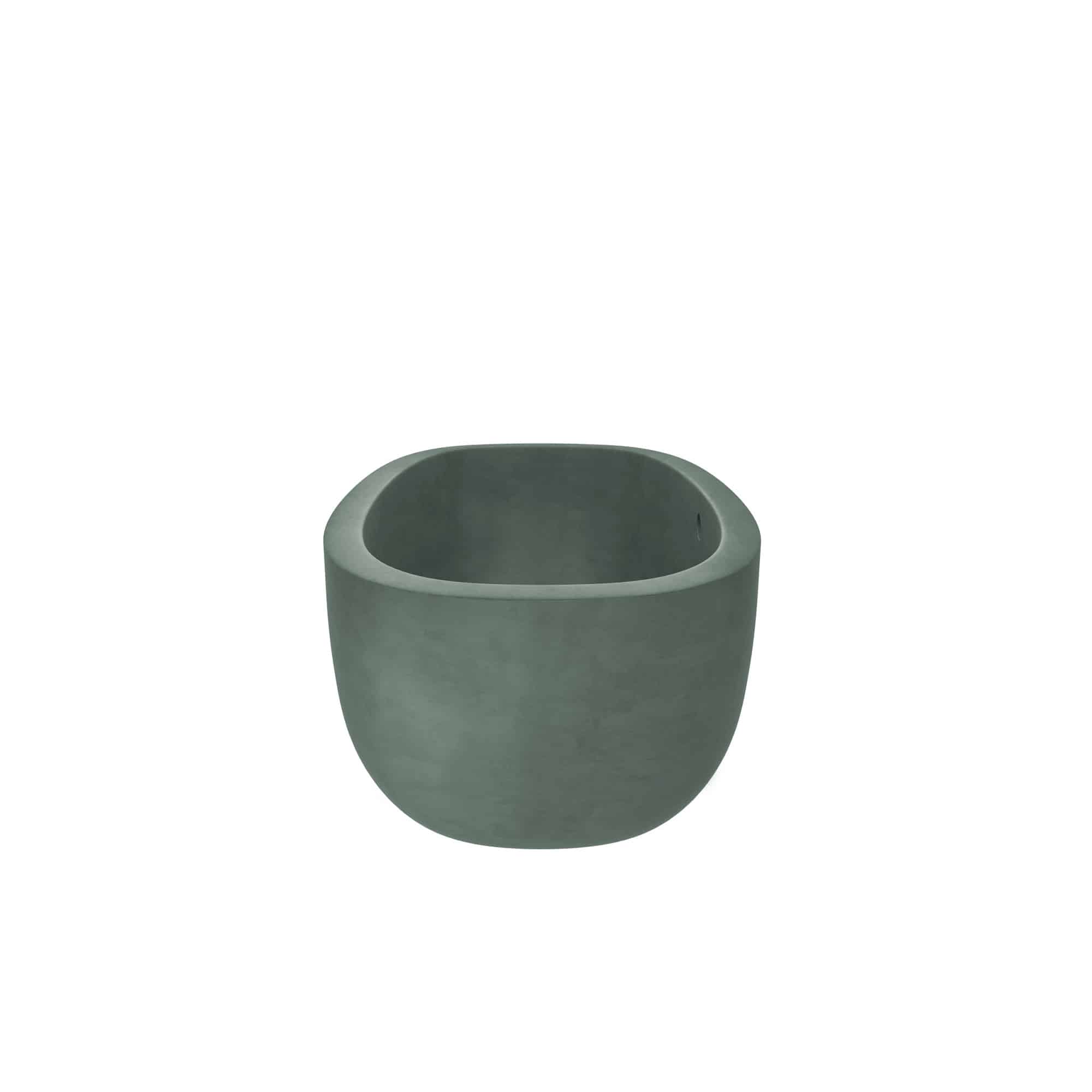 Forest green concrete soaking tub with rounded edges and wide rim, shown from front angle.