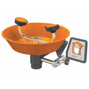 Wall-mounted eye wash station with orange plastic bowl, dual eye wash heads, black handles, and instruction sign.