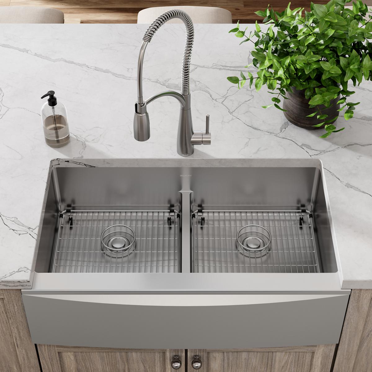 Stainless steel sink grid with vertical ribbed pattern, two circular drain holes, fits double-basin farmhouse sink.