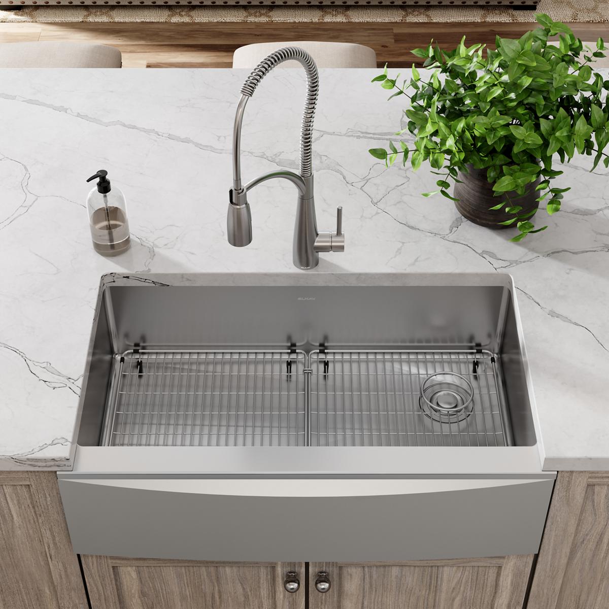 Stainless steel bottom grid with horizontal wire pattern inside kitchen sink basin.