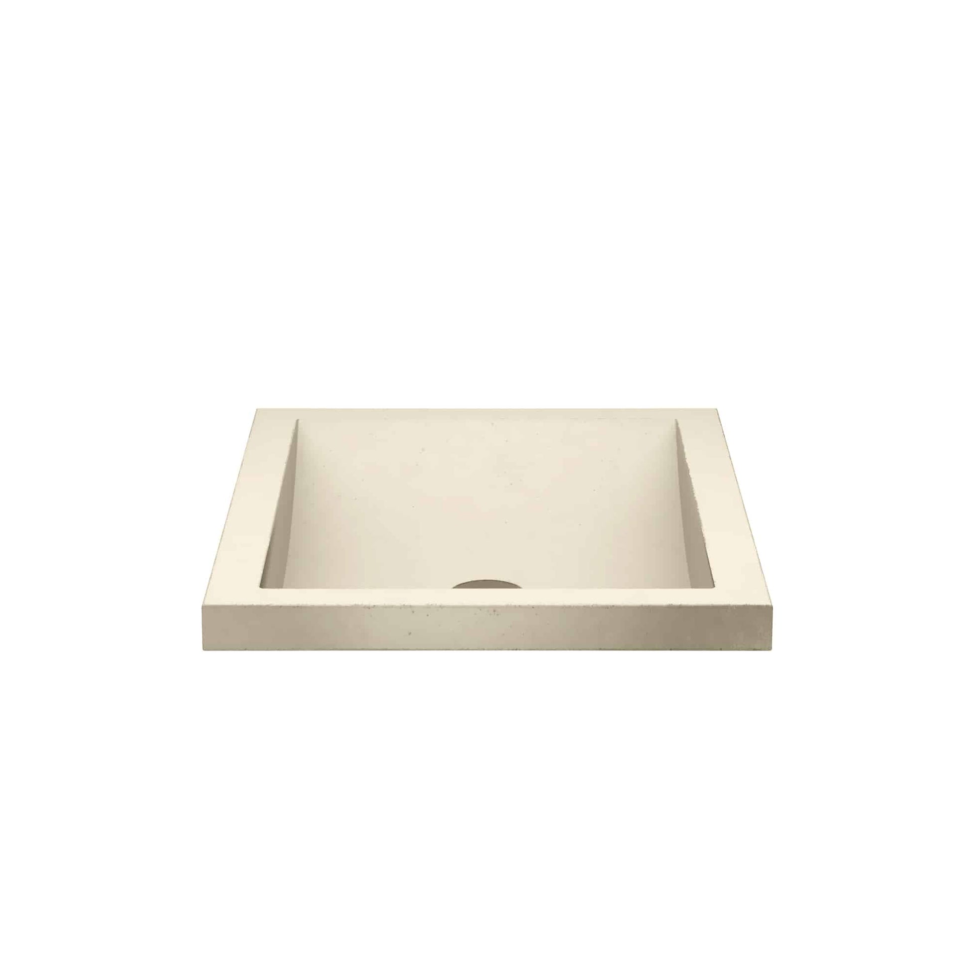 Sand-colored rectangular concrete sink with single basin and drain hole.