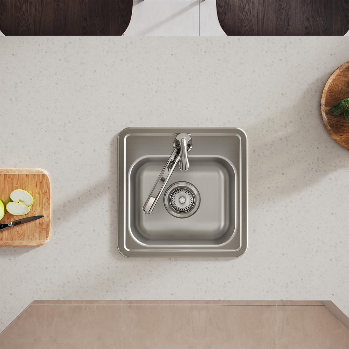 Stainless steel square drop-in bar sink with single bowl, drain strainer, and chrome faucet installed in light countertop.