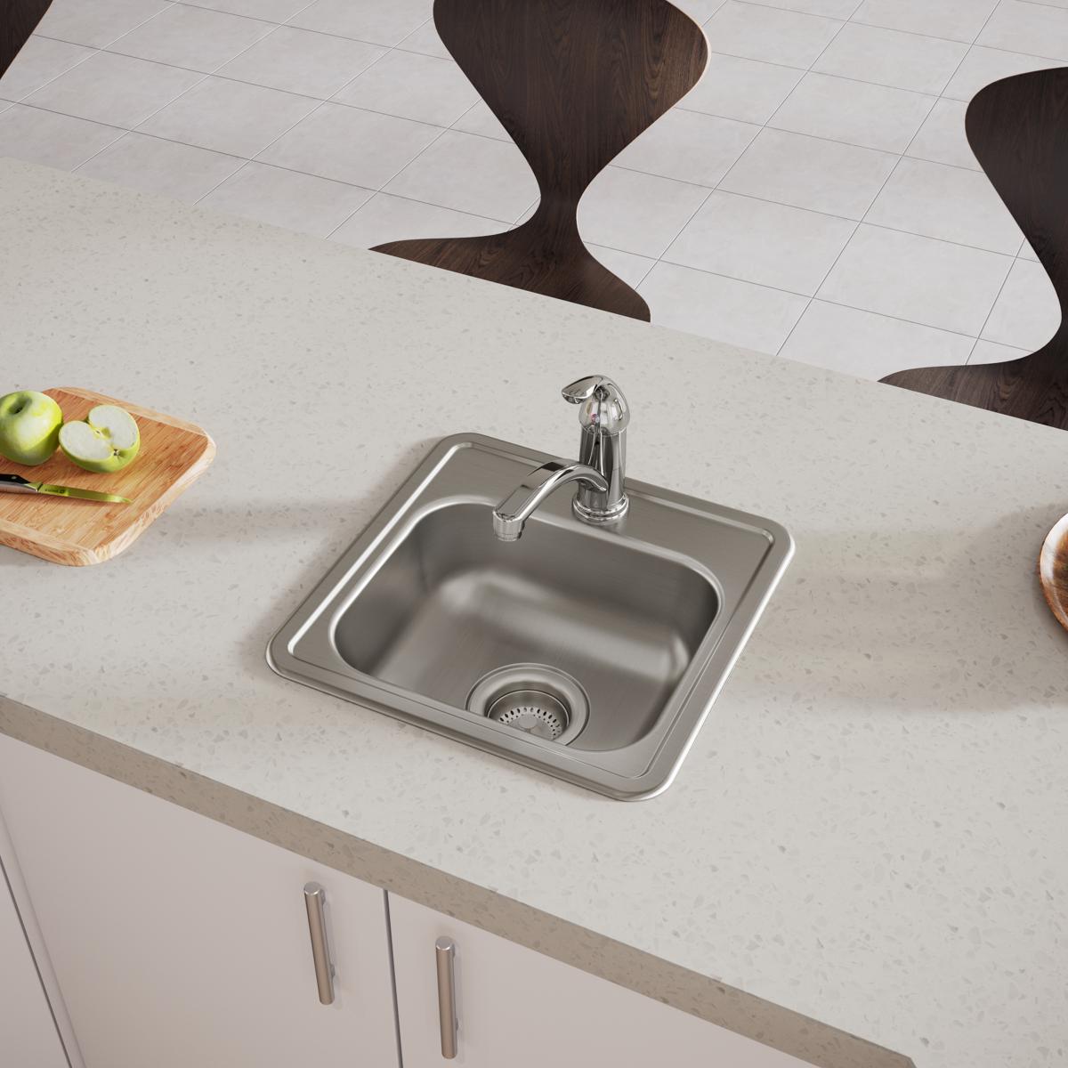 Stainless steel drop-in bar sink with single bowl, faucet, and strainer basket installed in countertop.