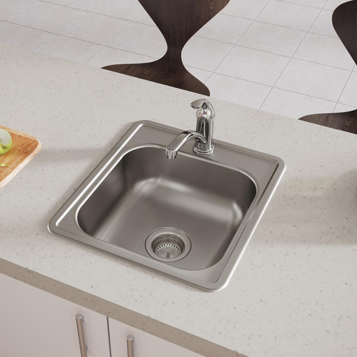 Stainless steel drop-in bar sink with single bowl, faucet, and drain strainer installed in countertop.