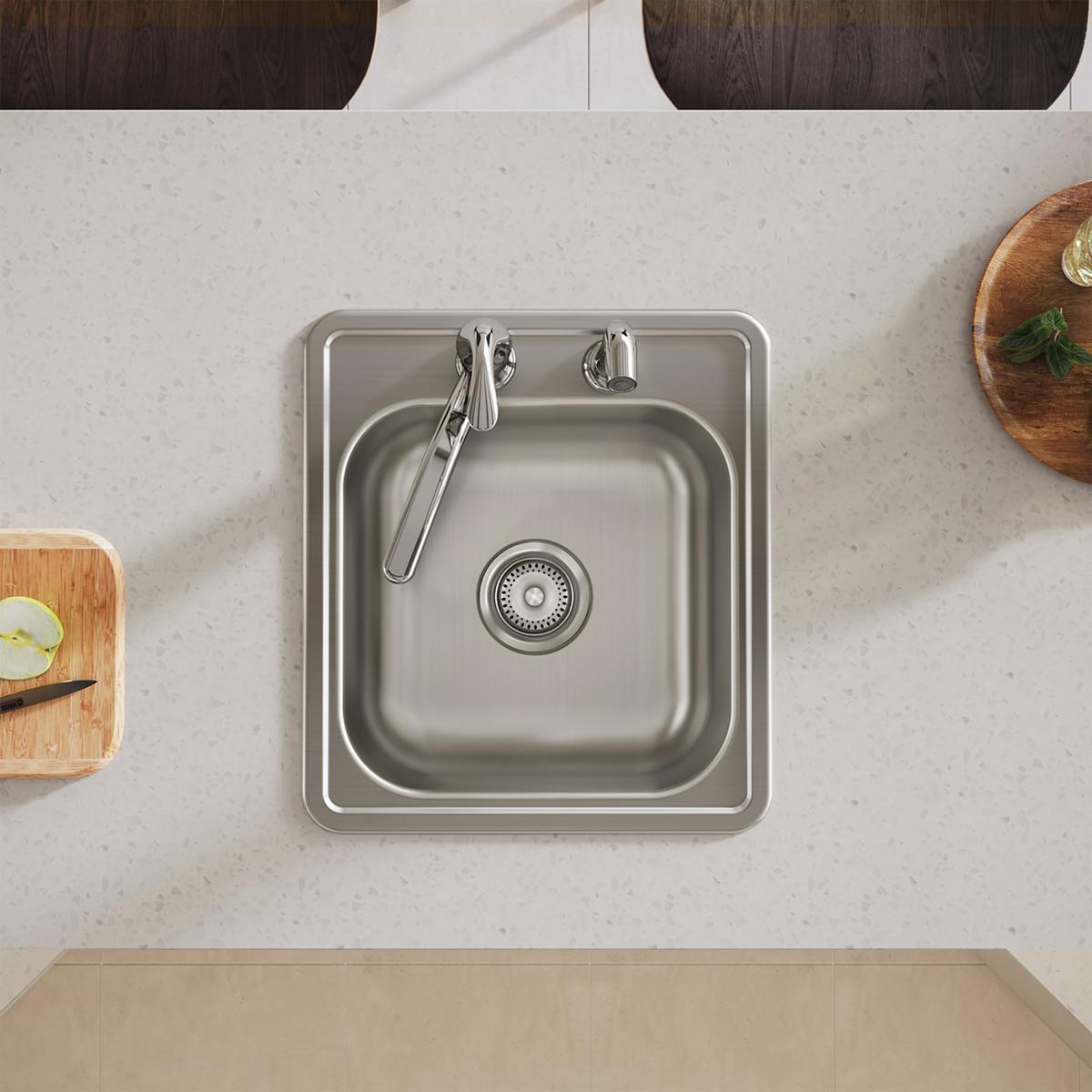 Stainless steel square drop-in bar sink with single bowl, two faucet holes, and drain strainer installed in countertop.