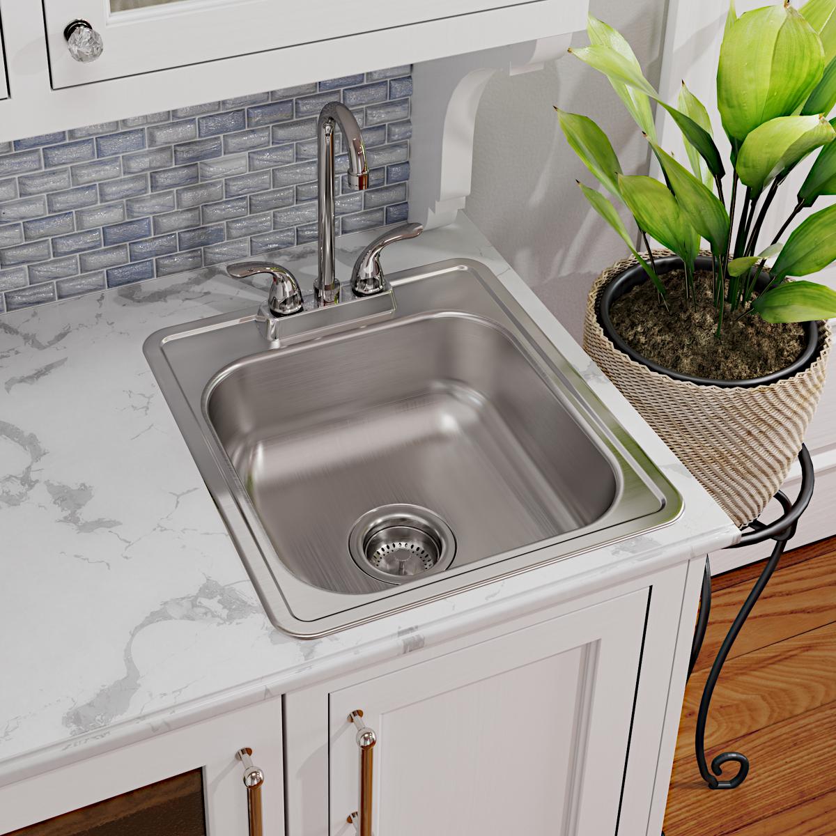 Stainless steel single bowl drop-in bar sink with chrome faucet installed in white countertop.