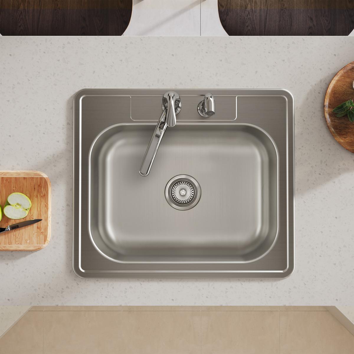 Stainless steel drop-in sink with single bowl, faucet, and two mounting holes installed in countertop.